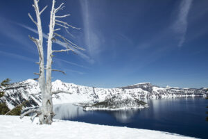 The deep blue water of Crater Lake ringed by caldera cliffs in Oregon