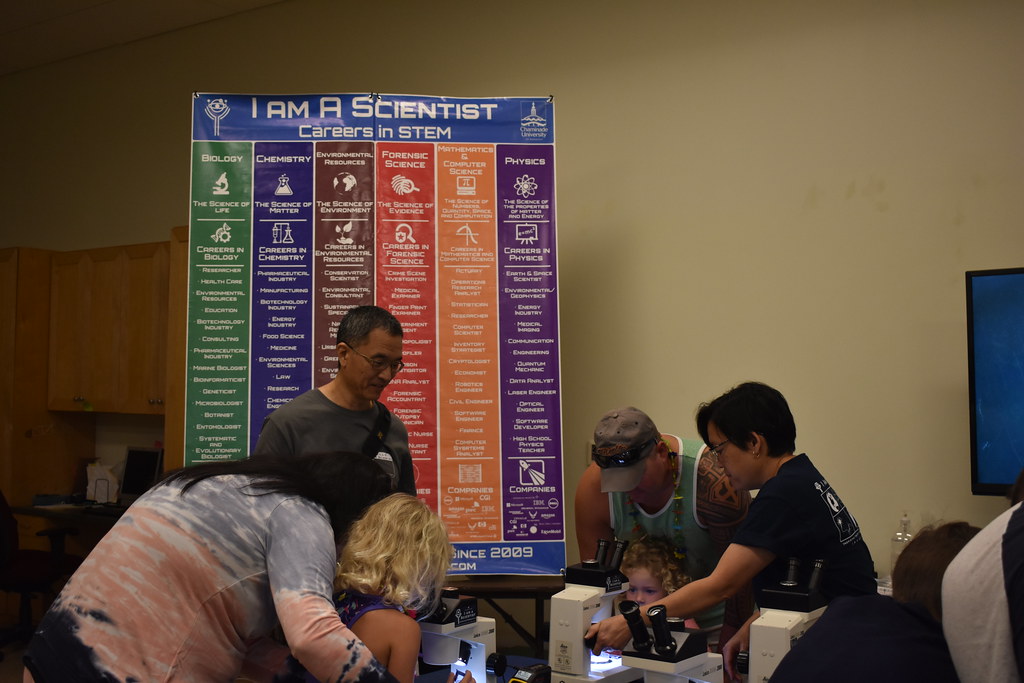 Children taking part in hands-on interactive science activities at a museum exhibit table