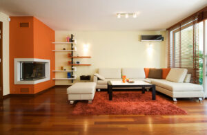 A bright modern living room with a fireplace, sofa and large windows